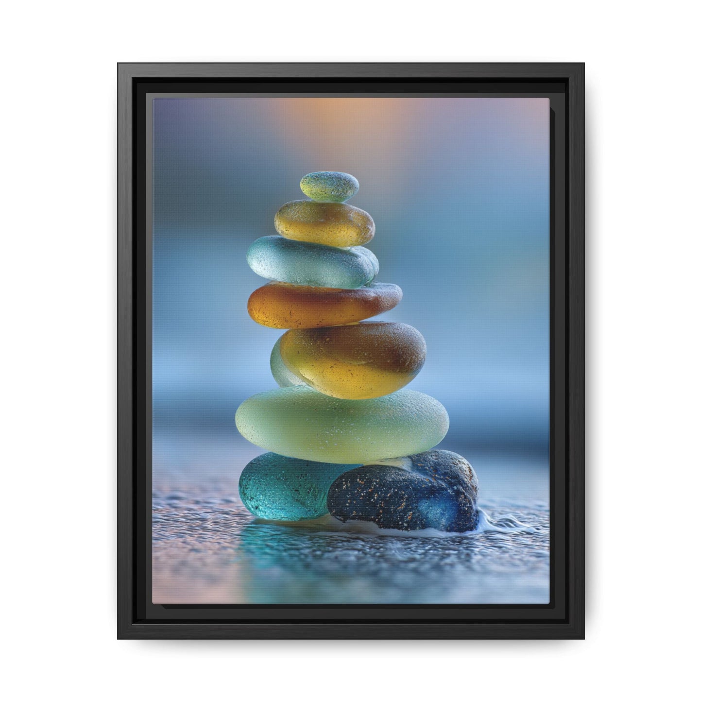 Framed canvas wall art of stacked calming green stones with a soft blue background