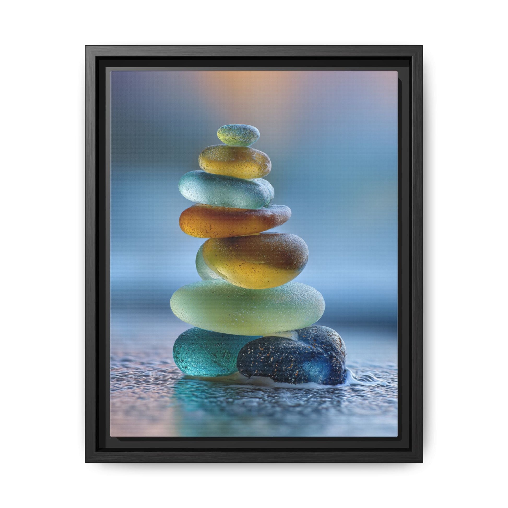 Framed canvas wall art of stacked calming green stones with a soft blue background