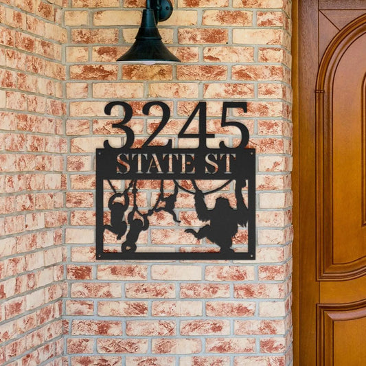 Funny Monkey Metal House Numbers custom black address sign with monkey design on brick wall near wooden door